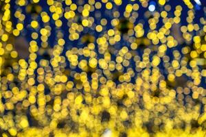 Blured festive garlands with glowing light bulbs against the background of the night sky. photo