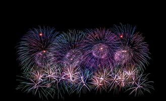 Colorful celebration fireworks isolated on a black sky background. photo