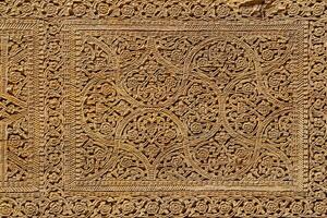 Fragment of an ancient carved wooden door. Ornate. photo