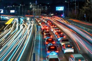 coche tráfico ligero a noche ciudad. foto