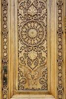 Fragment of an ancient carved wooden door. Ornate. photo