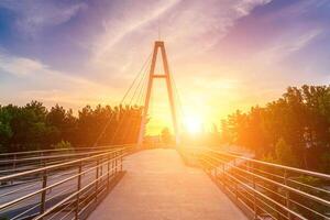 Modern footbridge across the Anhor canal in Navruz park at sunset in summertime, Uzbekistan, Tashkent. photo