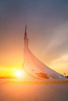 UZBEKISTAN, TASHKENT - MAY 5, 2023 Monument of Independence in the form of a stele with a Humo bird on a sunset in the New Uzbekistan. photo