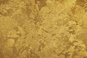 Texture of golden decorative plaster or concrete. Abstract gold grunge background. photo