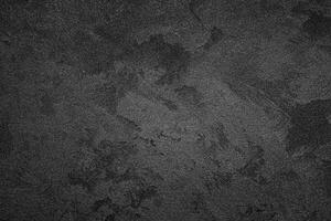 Texture of black decorative plaster or concrete with vignette. Abstract grunge background. photo
