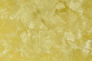 Texture of golden decorative plaster or concrete. Abstract gold grunge background. photo