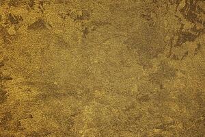 Texture of golden decorative plaster or concrete. Abstract gold grunge background. photo