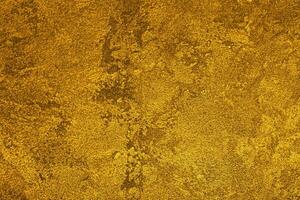 Texture of golden decorative plaster or concrete. Abstract gold grunge background. photo