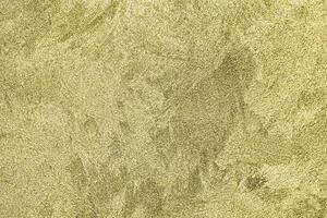 Texture of golden decorative plaster or concrete. Abstract gold grunge background. photo