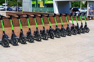 Tashkent, Uzbekistan - May 25, 2023 Rental of electric scooters parked on the sidewalk. photo