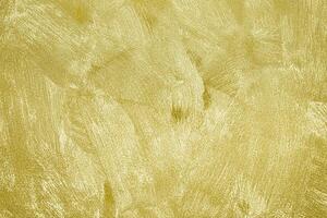 Texture of golden decorative plaster or concrete. Abstract gold grunge background. photo