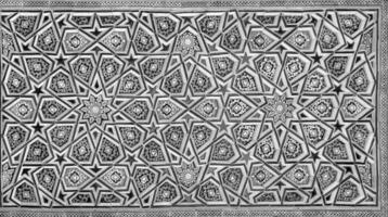 Geometric traditional Islamic ornament. Fragment of a ceramic mosaic. Black and white. photo