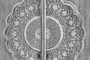 Carved wooden doors with patterns and mosaics. Black and white. photo