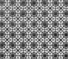 Geometric traditional Islamic ornament. Fragment of a ceramic mosaic. Black and white. photo