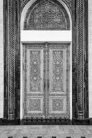 Carved wooden doors with patterns and mosaics. Black and white. photo