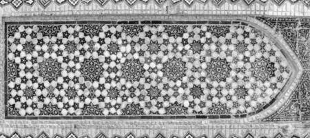 Geometric traditional Islamic ornament. Fragment of a ceramic mosaic. Black and white. photo