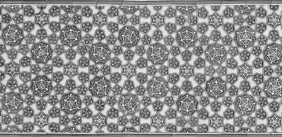 Geometric traditional Islamic ornament. Fragment of a ceramic mosaic. Black and white. photo