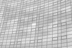 Black and white fragment of a modern office building. Abstract geometric background. Part of the facade of a skyscraper with glass windows. photo