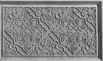Carved wooden doors with patterns and mosaics. Black and white. photo
