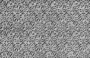 Geometric traditional Islamic ornament. Fragment of a concrete mosaic. Black and white. photo