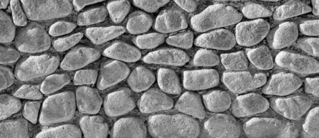 Black and white texture of an old antique stone wall. Abstract background. photo