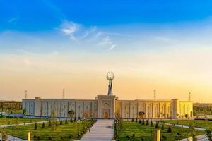 UZBEKISTAN, TASHKENT - APRIL 25, 2023 The territory of the park New Uzbekistan with Monument of Independence in the form of a stele with a Humo bird at twilight. photo