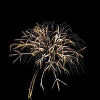 Colorful celebration fireworks isolated on a black sky background. photo