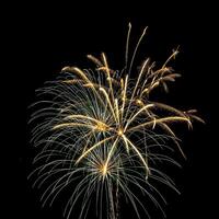 Colorful celebration fireworks isolated on a black sky background. photo