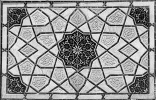 Geometric traditional Islamic ornament. Fragment of a ceramic mosaic. Black and white. photo