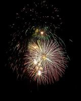 Colorful celebration fireworks isolated on a black sky background. photo