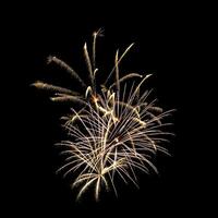 Colorful celebration fireworks isolated on a black sky background. photo