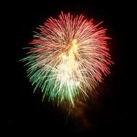 Colorful celebration fireworks isolated on a black sky background. photo