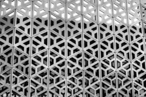 The texture of the cladding of a building made of metal aluminum panels with a carved pattern. Abstract background. Black and white. photo
