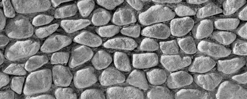 Black and white texture of an old antique stone wall. Abstract background. photo