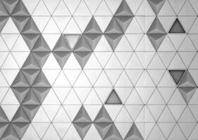 Steel diamond-shaped polished metal cladding panels of a modern building. Abstract monochrome background. photo