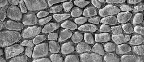 Black and white texture of an old antique stone wall. Abstract background. photo