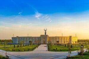 UZBEKISTAN, TASHKENT - APRIL 25, 2023 The territory of the park New Uzbekistan with Monument of Independence in the form of a stele with a Humo bird at twilight. photo