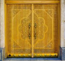 Carved wooden doors with patterns and mosaics. photo