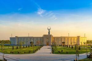 UZBEKISTAN, TASHKENT - APRIL 25, 2023 The territory of the park New Uzbekistan with Monument of Independence in the form of a stele with a Humo bird at twilight. photo