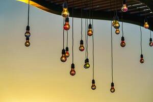 Festive hanging garlands with light bulbs against the background of a twilight sky. photo