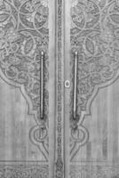 Black and white Carved wooden doors with patterns and mosaics. photo