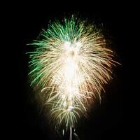 Colorful celebration fireworks isolated on a black sky background. photo