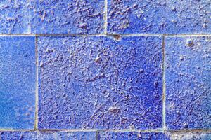 Colorful graffiti painted on a decorative brick like tiles. Abstract urban background. Spray painting art. photo