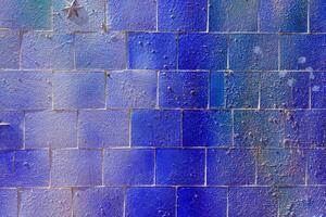 Colorful graffiti painted on a decorative brick like tiles. Abstract urban background. Spray painting art. photo