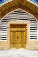 Carved wooden doors with patterns and mosaics. photo