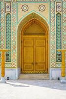 Carved wooden doors with patterns and mosaics. photo