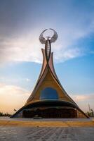 UZBEKISTAN, TASHKENT - APRIL 25, 2023 Monument of Independence in the form of a stele with a Humo bird on a sunset in the New Uzbekistan. photo