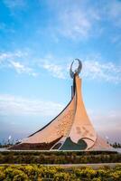 UZBEKISTAN, TASHKENT - APRIL 25, 2023 Monument of Independence in the form of a stele with a Humo bird on a sunset in the New Uzbekistan. photo