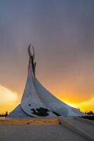 UZBEKISTAN, TASHKENT - APRIL 25, 2023 Monument of Independence in the form of a stele with a Humo bird on a sunset in the New Uzbekistan. photo