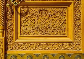 Fragment of a carved wooden door. Ornate. photo